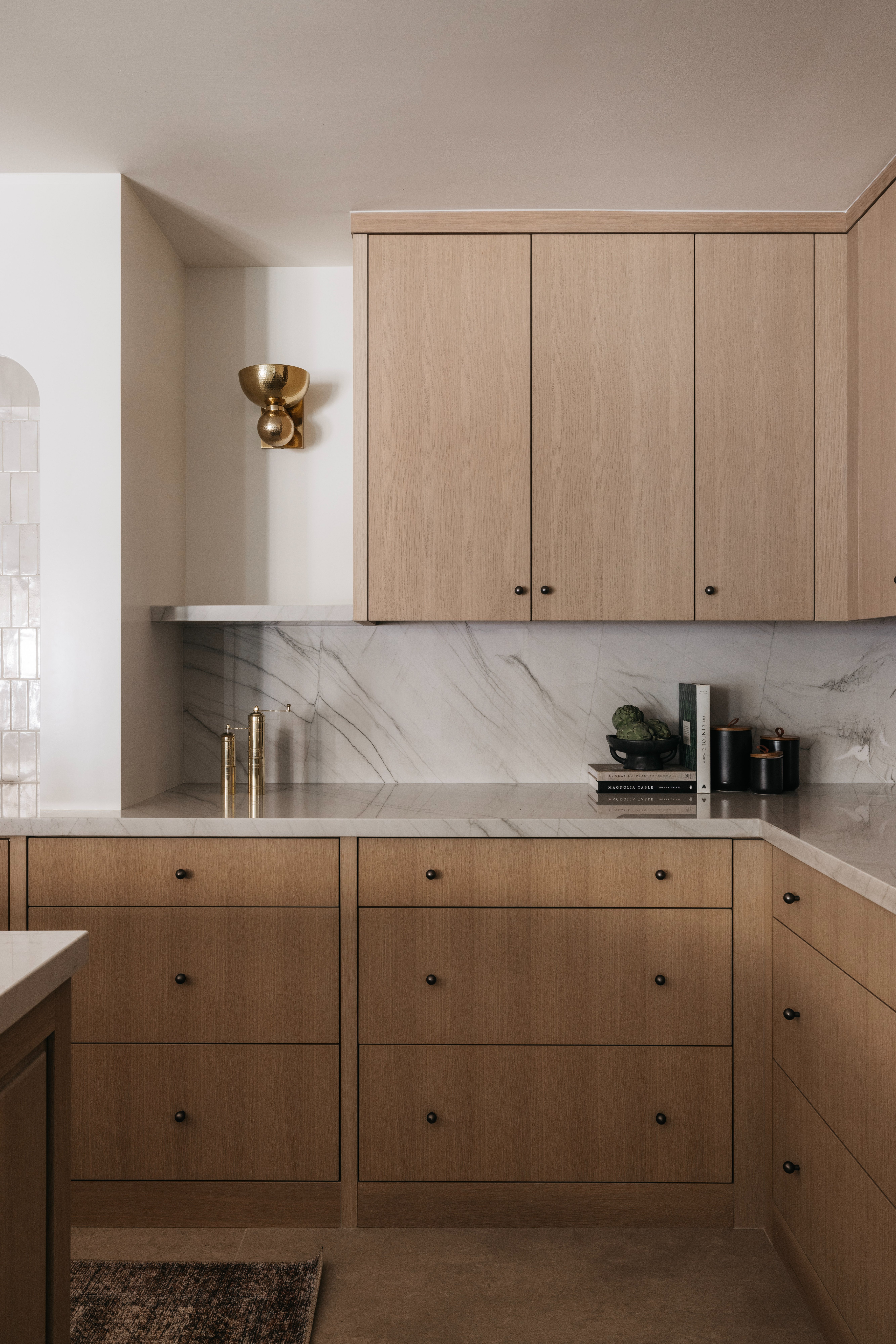 Counter and cabinetry detail with sconce, Golden Ranch